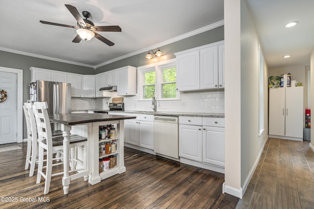 1409 Indian Fields Rd, Bethlehem, NY 12067 - kitchen with stainless steel appliances, white cabinetry, dark wood-type flooring, backsplash, and ornamental molding
