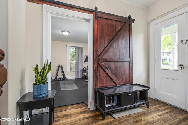 1409 Indian Fields Rd, Bethlehem, NY 12067 - entrance foyer featuring a barn door, crown molding, and wood finished floors
