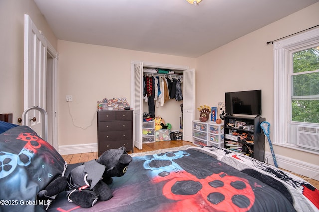 1409 Indian Fields Rd, Bethlehem, NY 12067 - bedroom with wood finished floors, baseboards, and a closet