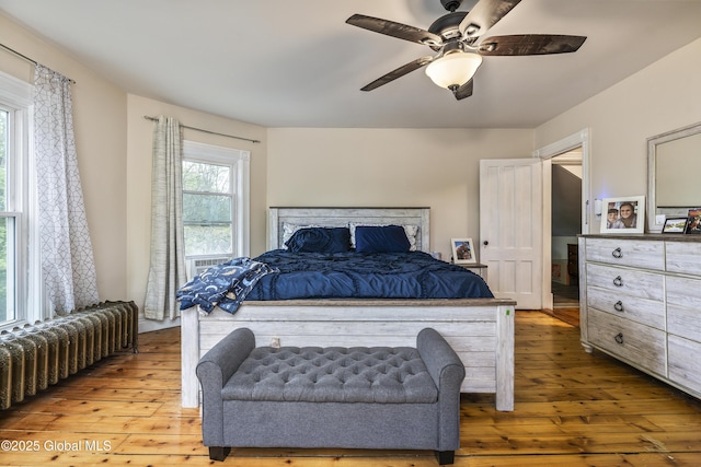 1409 Indian Fields Rd, Bethlehem, NY 12067 - bedroom featuring radiator, hardwood / wood-style floors, and ceiling fan