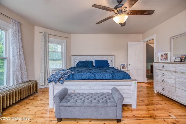 1409 Indian Fields Rd, Bethlehem, NY 12067 - bedroom with radiator, light wood finished floors, and a ceiling fan