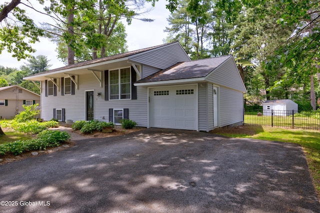 7 Hathorn Blvd, Saratoga Springs, NY 12866 - raised ranch featuring asphalt driveway, a garage, and a shingled roof