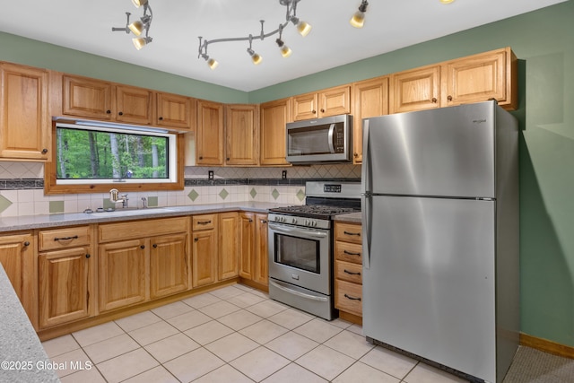 401 Wilton Gansevoort Rd, Wilton, NY 12831 - kitchen with appliances with stainless steel finishes, a sink, backsplash, and light tile patterned floors