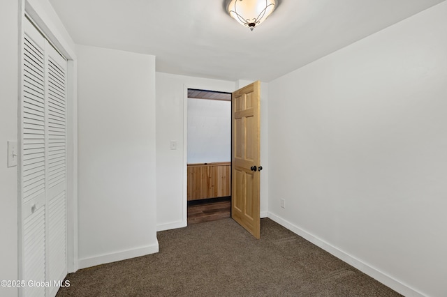 401 Wilton Gansevoort Rd, Wilton, NY 12831 - unfurnished bedroom with dark carpet, a closet, and baseboards