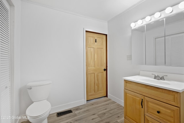 401 Wilton Gansevoort Rd, Wilton, NY 12831 - bathroom featuring a closet, vanity, toilet, wood finished floors, and baseboards