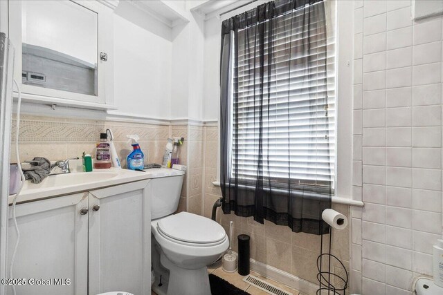57 O Connell St, Albany, NY 12209 - bathroom featuring tile walls, vanity, and toilet