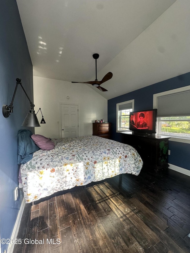 bedroom with wood-type flooring, lofted ceiling, and baseboards