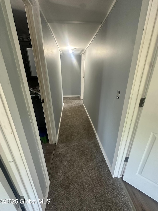 hall with carpet flooring and baseboards