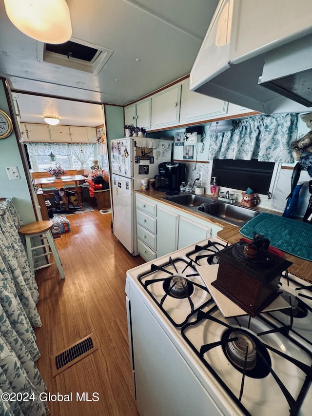 783 Woodstock Rd Lot 3, Berne, NY 12059 - kitchen with white appliances, white cabinetry, a sink, and wood finished floors