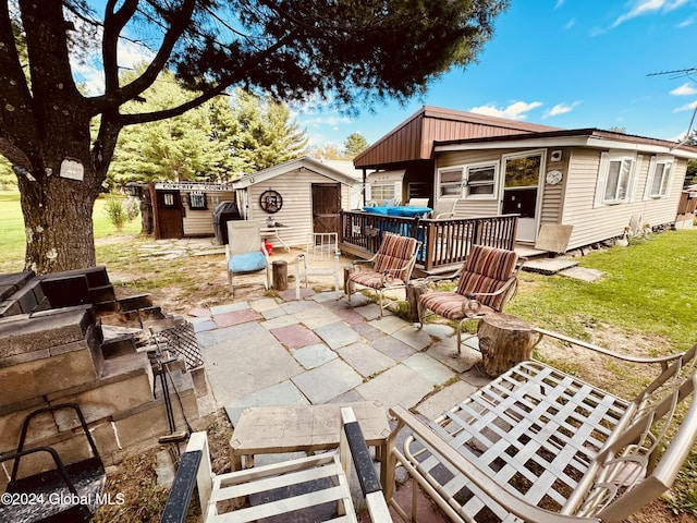 783 Woodstock Rd Lot 3, Berne, NY 12059 - view of patio featuring a storage unit, an outbuilding, a deck, and exterior kitchen