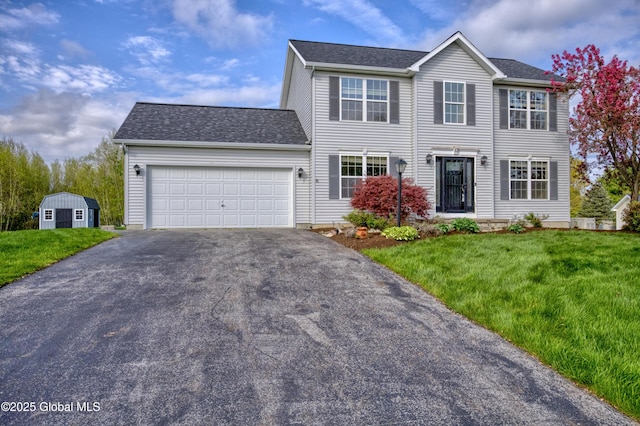 13 Peach Tree Ln, Wilton, NY 12831 - colonial-style house with asphalt driveway, an attached garage, a front yard, and a shed