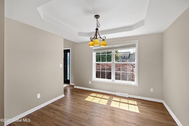 13 Peach Tree Ln, Wilton, NY 12831 - spare room featuring a tray ceiling, baseboards, a chandelier, and wood finished floors
