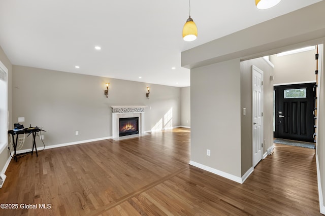 13 Peach Tree Ln, Wilton, NY 12831 - unfurnished living room with wood finished floors, baseboards, a fireplace with flush hearth, and recessed lighting