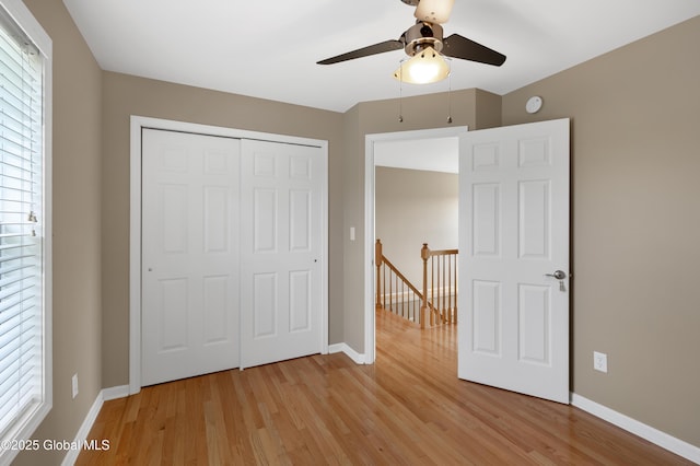 13 Peach Tree Ln, Wilton, NY 12831 - unfurnished bedroom featuring light wood-style flooring, a closet, baseboards, and ceiling fan