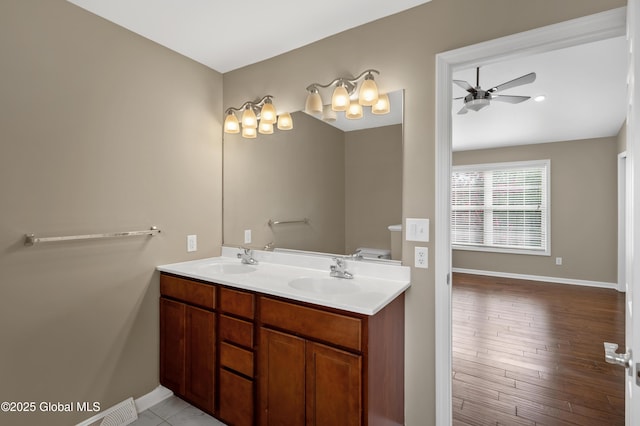 13 Peach Tree Ln, Wilton, NY 12831 - full bathroom featuring baseboards, a ceiling fan, double vanity, and wood finished floors