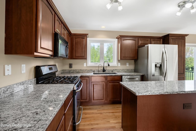 13 Peach Tree Ln, Wilton, NY 12831 - kitchen with stainless steel appliances, a sink, light wood finished floors, and light stone countertops