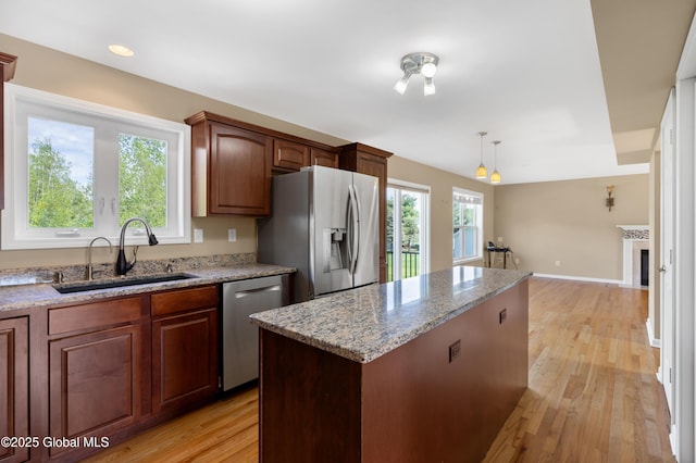 13 Peach Tree Ln, Wilton, NY 12831 - kitchen with a sink, stainless steel appliances, a center island, light wood-style flooring, and light stone countertops