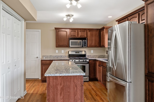 13 Peach Tree Ln, Wilton, NY 12831 - kitchen featuring appliances with stainless steel finishes, a center island, light wood finished floors, light stone counters, and recessed lighting