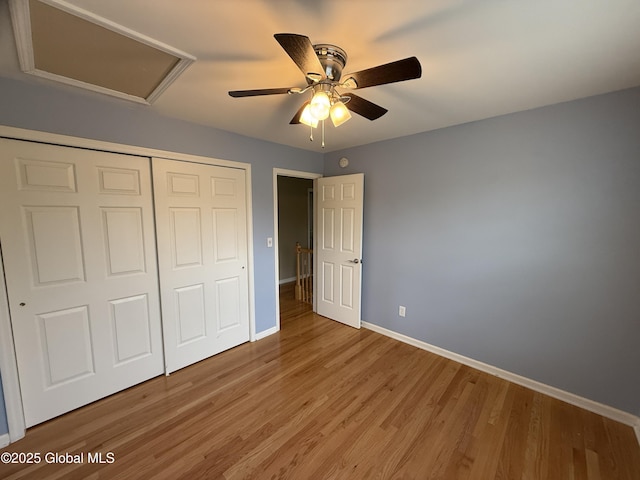 13 Peach Tree Ln, Wilton, NY 12831 - unfurnished bedroom with baseboards, attic access, wood finished floors, a closet, and ceiling fan