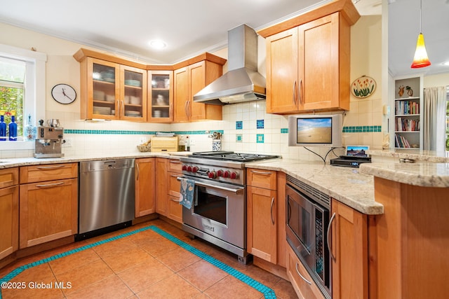 2 Loudon Pkwy, Colonie, NY 12211 - kitchen featuring appliances with stainless steel finishes, wall chimney range hood, a peninsula, light tile patterned flooring, and backsplash
