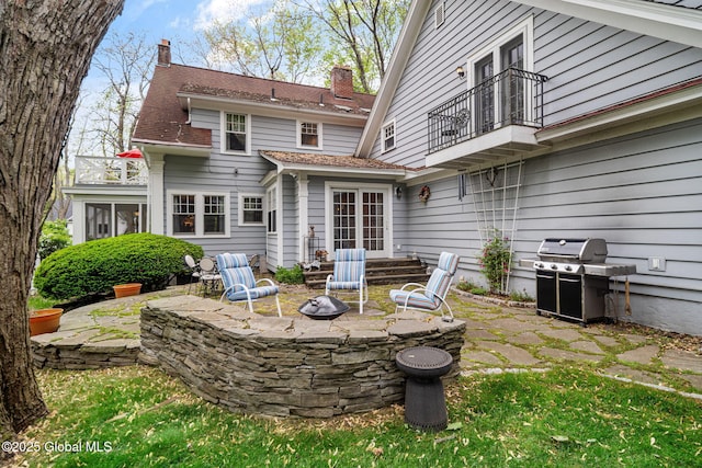 2 Loudon Pkwy, Colonie, NY 12211 - back of house with a balcony, a patio, a fire pit, and a chimney