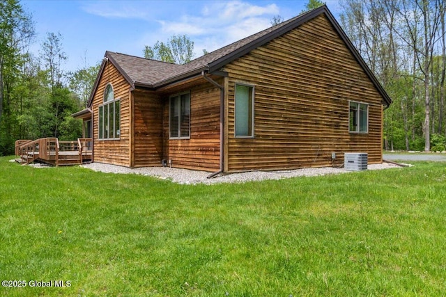 2158 State Route 29, Greenwich, NY 12834 - view of property exterior featuring central AC unit, a yard, a wooden deck, and a shingled roof