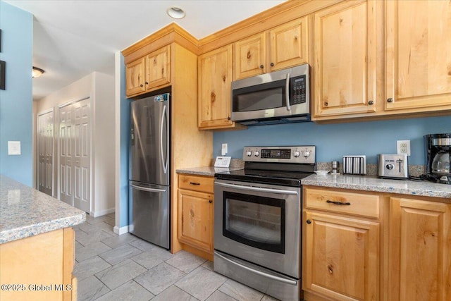 2158 State Route 29, Greenwich, NY 12834 - kitchen featuring stainless steel appliances, light stone countertops, baseboards, and light brown cabinets