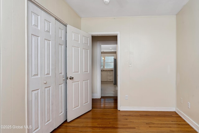 58 Old Loudon Rd, Colonie, NY 12110 - unfurnished bedroom featuring wood finished floors, a closet, a sink, and baseboards