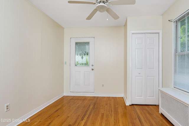 58 Old Loudon Rd, Colonie, NY 12110 - entrance foyer with light wood-style floors, radiator heating unit, ceiling fan, and baseboards
