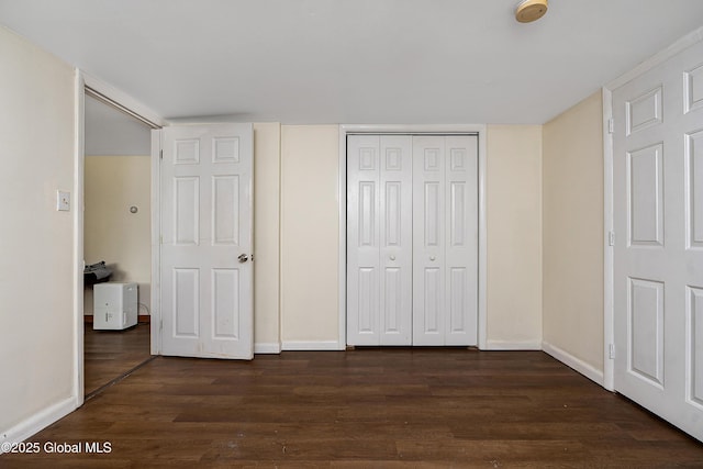 58 Old Loudon Rd, Colonie, NY 12110 - unfurnished bedroom with dark wood-style floors, a closet, and baseboards