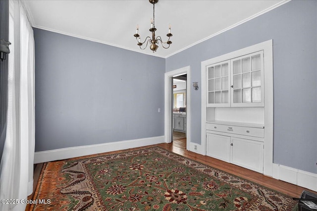 302 S William St, Johnstown, NY 12095 - unfurnished dining area featuring dark wood-style floors, a chandelier, and ornamental molding