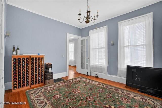 302 S William St, Johnstown, NY 12095 - dining area with a chandelier, crown molding, and wood finished floors