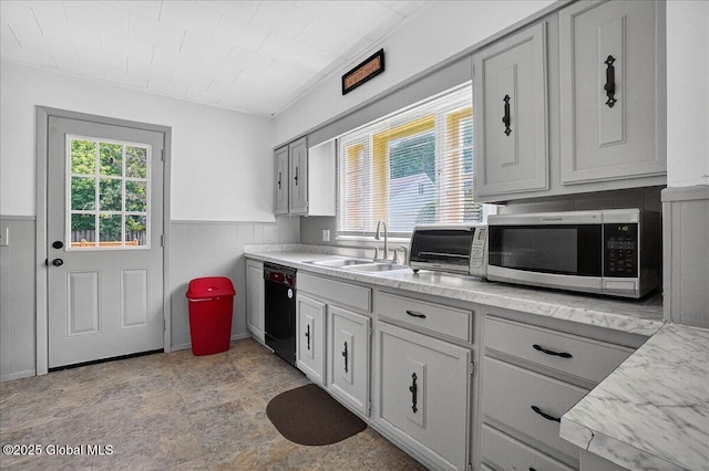 302 S William St, Johnstown, NY 12095 - kitchen featuring stainless steel microwave, dishwasher, light countertops, and wainscoting