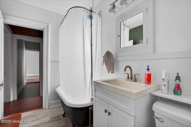 302 S William St, Johnstown, NY 12095 - full bathroom featuring vanity, tasteful backsplash, wood finished floors, and a shower with curtain