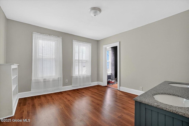 302 S William St, Johnstown, NY 12095 - empty room featuring dark wood-type flooring and baseboards