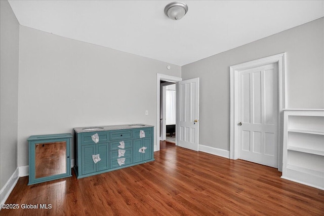 302 S William St, Johnstown, NY 12095 - unfurnished bedroom with dark wood-style flooring
