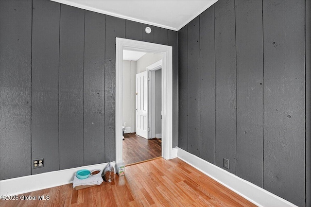 302 S William St, Johnstown, NY 12095 - spare room featuring wood finished floors, wood walls, and a smoke detector
