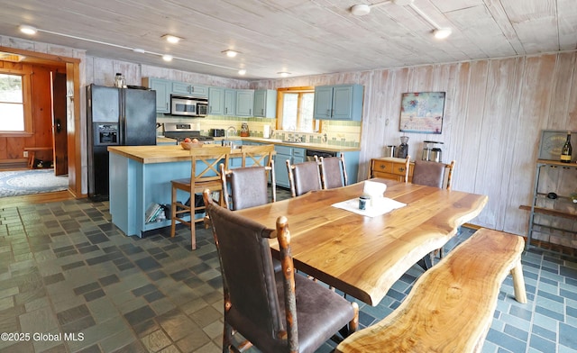 745 Adirondack Rd, Schroon Lake, NY 12870 - dining room featuring healthy amount of natural light, wood walls, and wooden ceiling