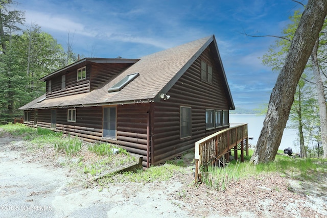 745 Adirondack Rd, Schroon Lake, NY 12870 - view of home's exterior with roof with shingles, a water view, and stairs