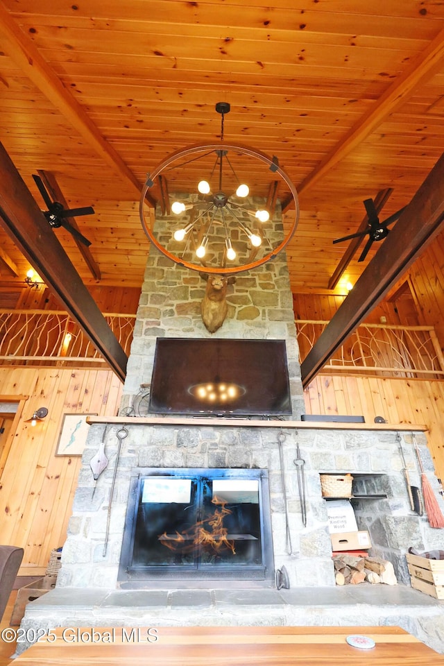 745 Adirondack Rd, Schroon Lake, NY 12870 - unfurnished living room with wooden ceiling with exposed beams, wood walls, a fireplace, a ceiling fan, and a chandelier