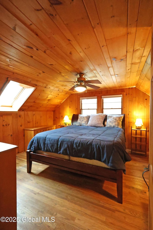 745 Adirondack Rd, Schroon Lake, NY 12870 - bedroom featuring vaulted ceiling, a skylight, light wood-type flooring, wood walls, and wooden ceiling