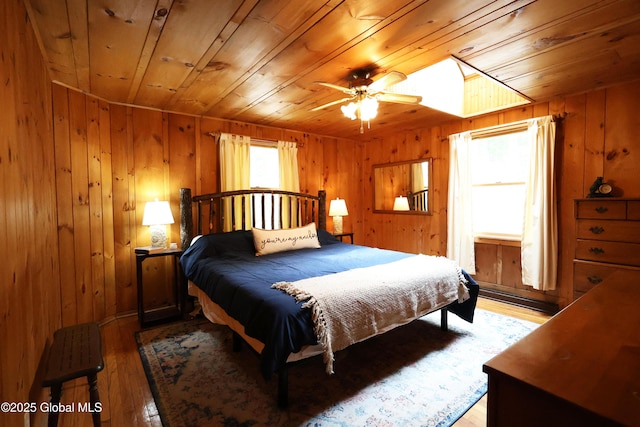 745 Adirondack Rd, Schroon Lake, NY 12870 - bedroom featuring wooden ceiling, a baseboard heating unit, light wood-style flooring, and wooden walls