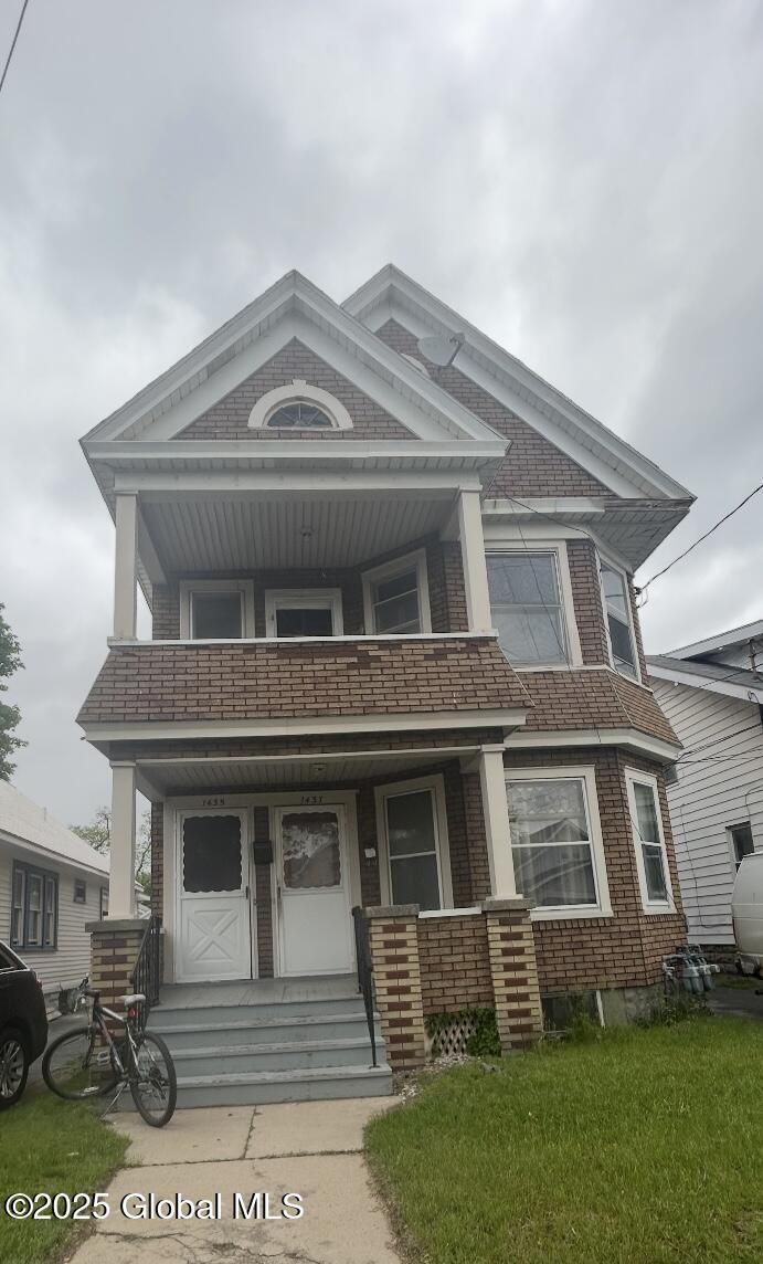 1435 Van Cortland St, Schenectady, NY 12303 - view of front of property with a balcony, a porch, and brick siding