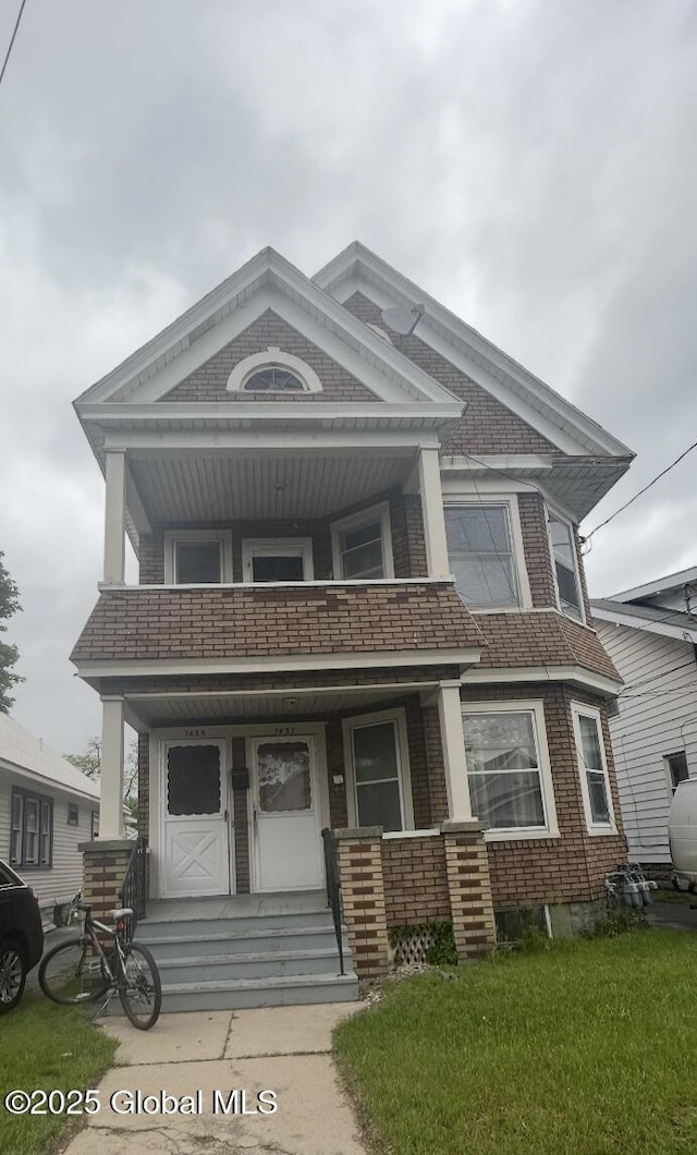 1435 Van Cortland St, Schenectady, NY 12303 - view of front of property with a balcony, a porch, and brick siding