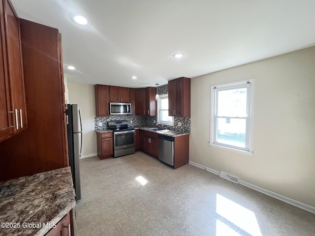 44 Park Ave, Colonie, NY 12110 - kitchen with appliances with stainless steel finishes, decorative backsplash, and recessed lighting