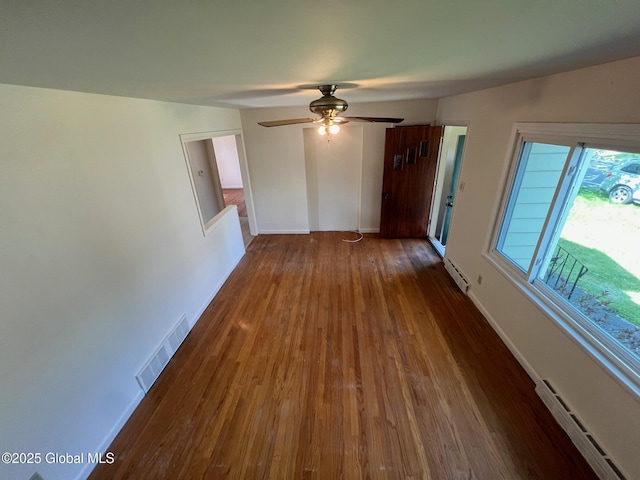 44 Park Ave, Colonie, NY 12110 - empty room featuring a baseboard radiator, a baseboard heating unit, wood finished floors, and a ceiling fan