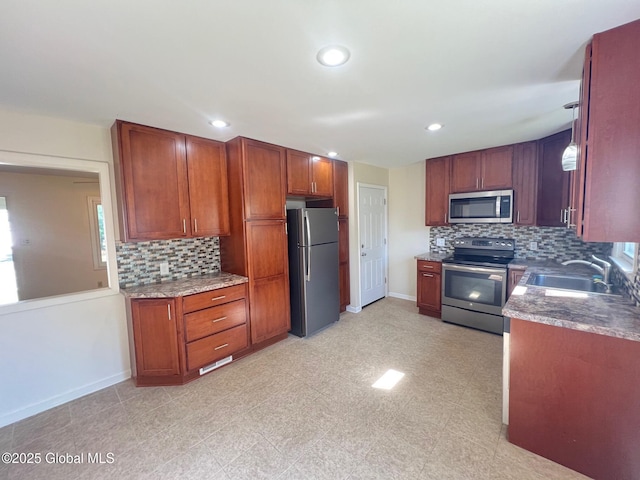 44 Park Ave, Colonie, NY 12110 - kitchen with stainless steel appliances, tasteful backsplash, recessed lighting, and brown cabinetry