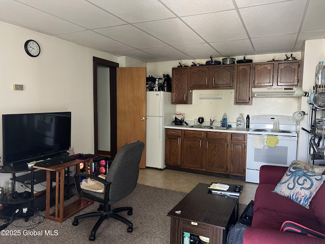 11 Williams St, Granville, NY 12832 - kitchen with white appliances, under cabinet range hood, a drop ceiling, a sink, and dark brown cabinets