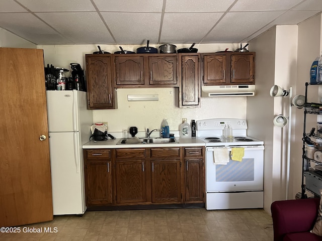 11 Williams St, Granville, NY 12832 - kitchen featuring white appliances, a sink, under cabinet range hood, a drop ceiling, and light countertops