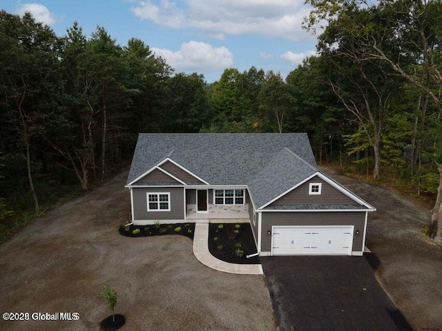 24 Nichols Rd, Wilton, NY 12831 - craftsman inspired home featuring asphalt driveway, an attached garage, and a wooded view